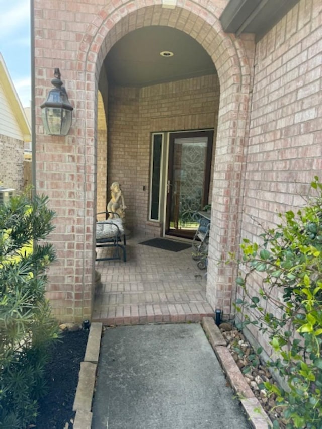 entrance to property with brick siding