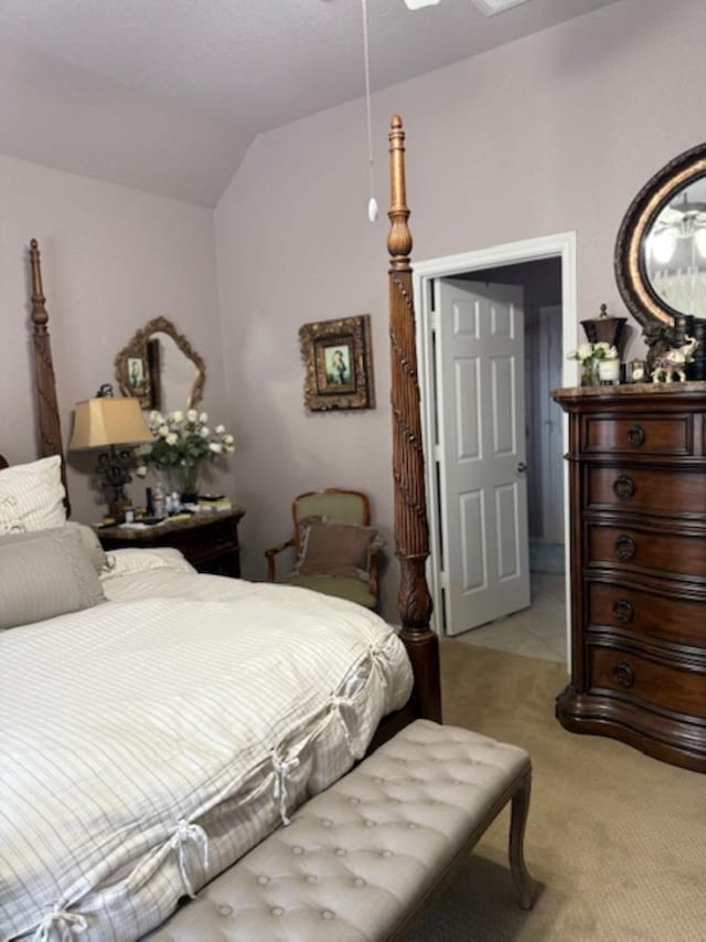 bedroom featuring light colored carpet and lofted ceiling