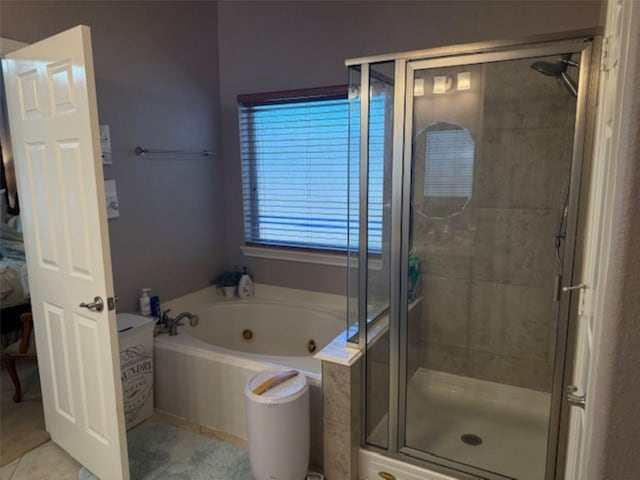 bathroom with a stall shower, a tub with jets, and tile patterned flooring