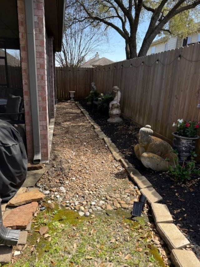 view of yard with a fenced backyard