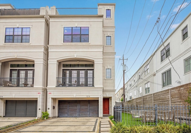 1214 Dunlavy St, Houston, TX 77019 - multi unit property with concrete driveway, an attached garage, and a balcony