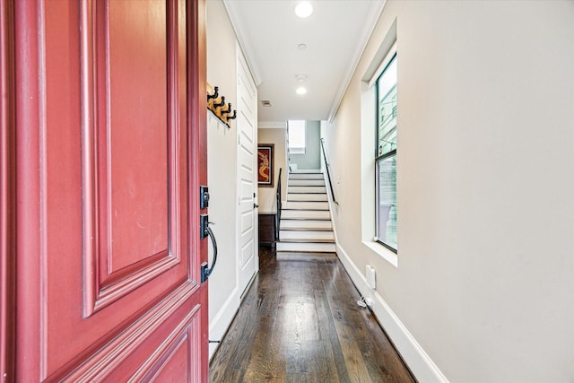 corridor with dark wood finished floors, plenty of natural light, baseboards, and stairway