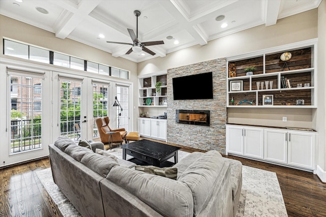 living room with a ceiling fan, plenty of natural light, and coffered ceiling