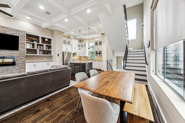 1214 Dunlavy St, Houston, TX 77019 - dining room featuring dark wood finished floors, beam ceiling, coffered ceiling, a fireplace, and stairway