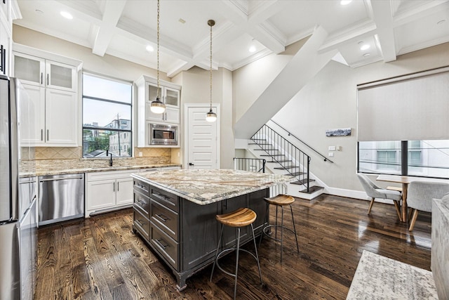 kitchen featuring beam ceiling, dark wood-style flooring, white cabinets, coffered ceiling, and appliances with stainless steel finishes