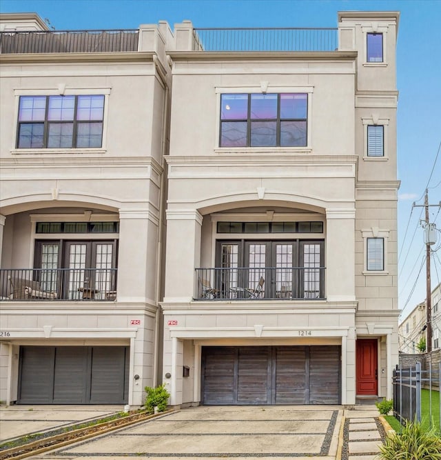 1214 Dunlavy St, Houston, TX 77019 - multi unit property featuring concrete driveway, a garage, a balcony, and stucco siding
