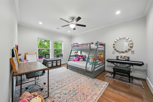 bedroom with wood finished floors, recessed lighting, crown molding, baseboards, and a desk