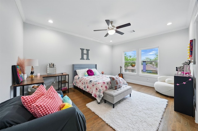 bedroom with recessed lighting, ornamental molding, ceiling fan, baseboards, and wood finished floors