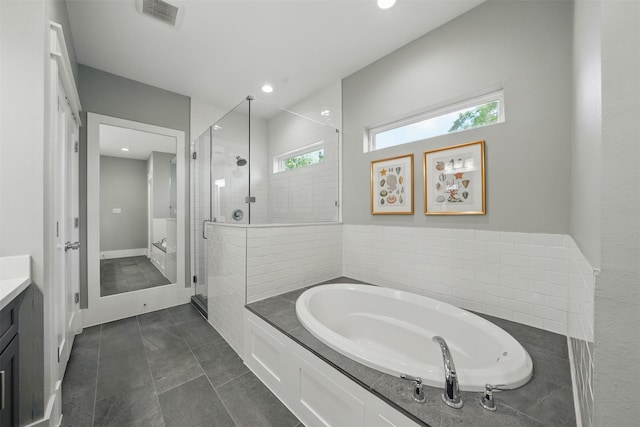 bathroom featuring a stall shower, vanity, a bath, plenty of natural light, and recessed lighting