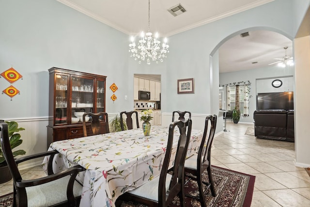 20714 Delta Wood Trl, Humble, TX 77346 - dining room featuring arched walkways, a ceiling fan, light tile patterned flooring, ornamental molding, and a chandelier