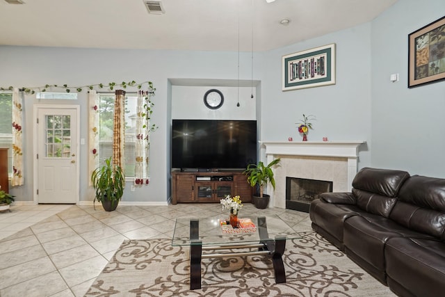20714 Delta Wood Trl, Humble, TX 77346 - living room with light tile patterned floors, a tiled fireplace, and baseboards