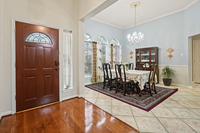 20714 Delta Wood Trl, Humble, TX 77346 - foyer featuring a chandelier, a towering ceiling, crown molding, baseboards, and tile patterned flooring