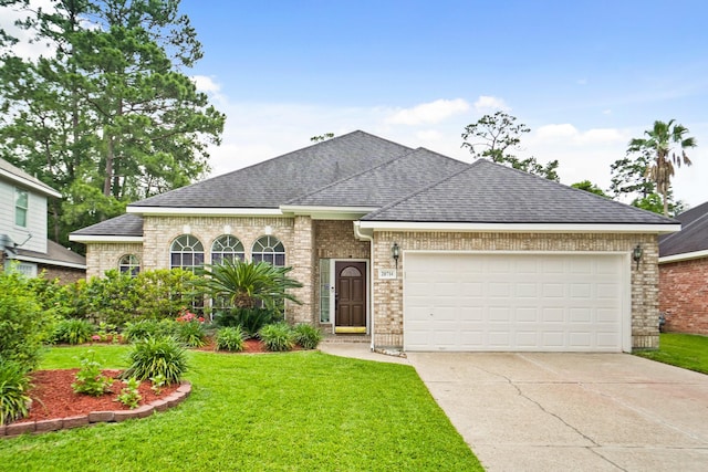 20714 Delta Wood Trl, Humble, TX 77346 - view of front of home featuring concrete driveway, a garage, brick siding, a front yard, and a shingled roof