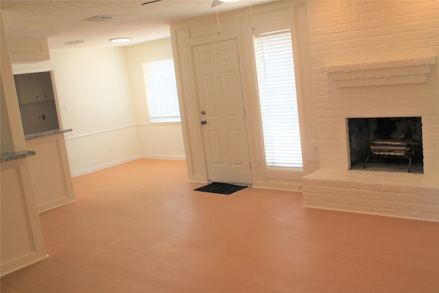 6103 Portal Dr, Houston, TX 77096 - foyer entrance with wood finished floors, ceiling fan, a fireplace, and baseboards