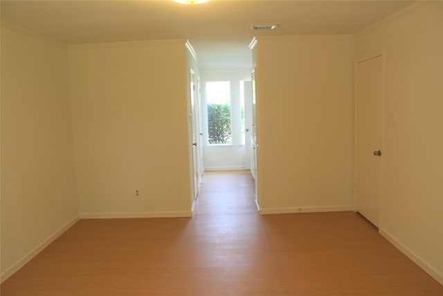 6103 Portal Dr, Houston, TX 77096 - empty room with crown molding, baseboards, and light wood-type flooring