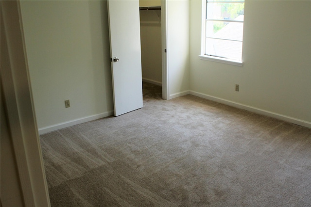 6103 Portal Dr, Houston, TX 77096 - unfurnished bedroom with carpet floors, baseboards, a closet, and a walk in closet