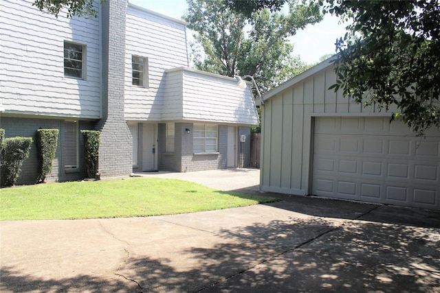6103 Portal Dr, Houston, TX 77096 - view of front of property featuring brick siding, driveway, a garage, and a front yard