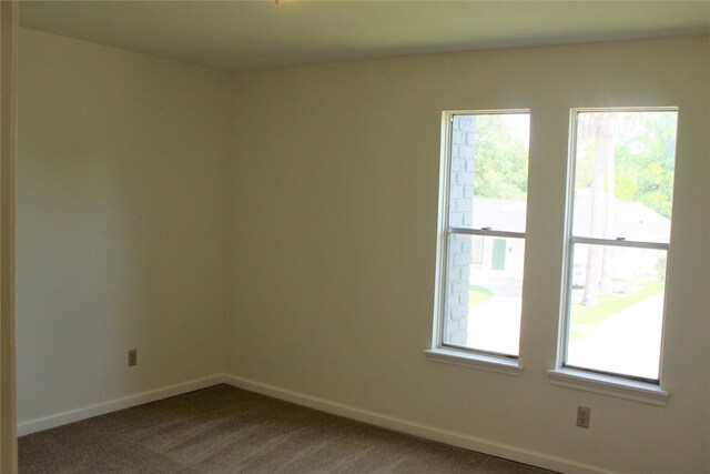 6103 Portal Dr, Houston, TX 77096 - empty room featuring dark carpet and baseboards