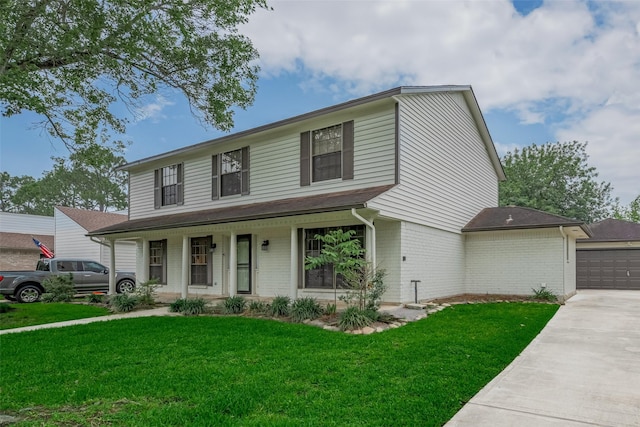 traditional-style home featuring brick siding, a porch, a front lawn, and a garage