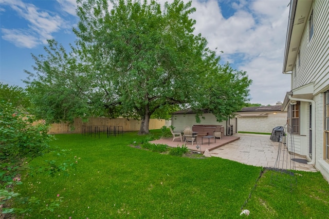 view of yard with a hot tub and a patio area