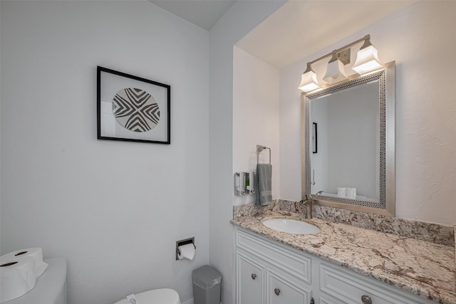 bathroom featuring toilet and vanity