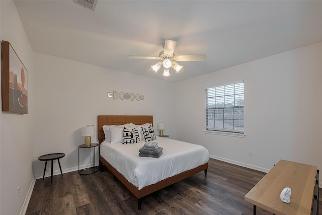 bedroom featuring dark wood-style flooring, baseboards, and a ceiling fan