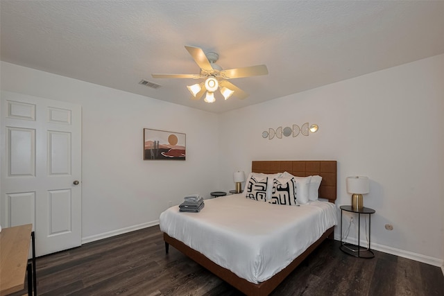 bedroom with dark wood-type flooring, baseboards, and a ceiling fan