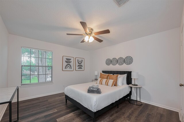 bedroom with dark wood-type flooring, baseboards, and ceiling fan