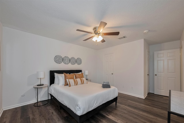 bedroom with baseboards, wood finished floors, ceiling fan, and a textured ceiling