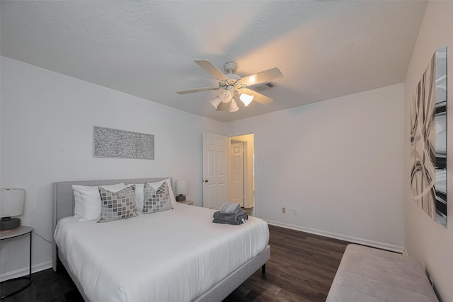 bedroom featuring baseboards, dark wood finished floors, and a ceiling fan
