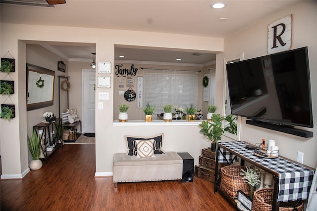 living room with crown molding, wood finished floors, baseboards, and recessed lighting