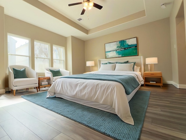 1438A Dian St, Houston, TX 77008 - bedroom featuring wood finished floors, a ceiling fan, visible vents, baseboards, and a raised ceiling
