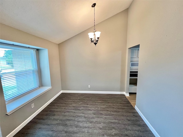 37 Ranch House Loop, Angleton, TX 77515 - unfurnished dining area featuring dark wood-type flooring, baseboards, lofted ceiling, and a notable chandelier