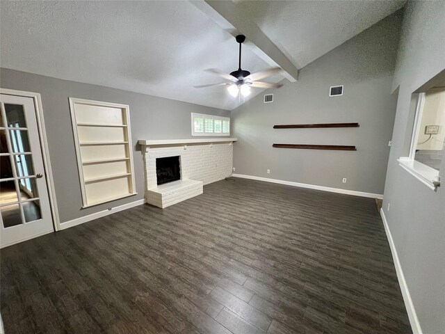 37 Ranch House Loop, Angleton, TX 77515 - unfurnished living room featuring a textured ceiling, ceiling fan, visible vents, a brick fireplace, and dark wood-type flooring