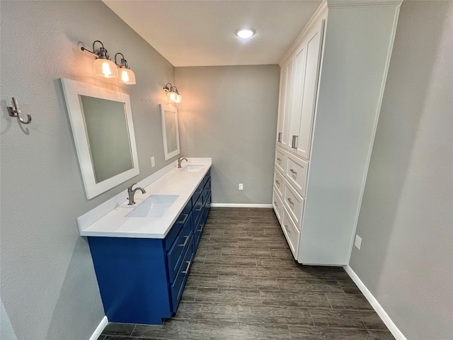 37 Ranch House Loop, Angleton, TX 77515 - full bath with a sink, double vanity, baseboards, and wood finished floors