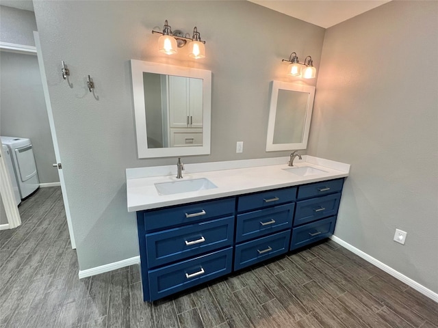 37 Ranch House Loop, Angleton, TX 77515 - full bathroom featuring a sink, washing machine and dryer, and wood finished floors