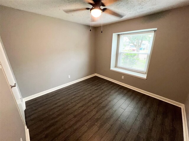 37 Ranch House Loop, Angleton, TX 77515 - unfurnished room featuring a ceiling fan, baseboards, a textured ceiling, and dark wood-type flooring