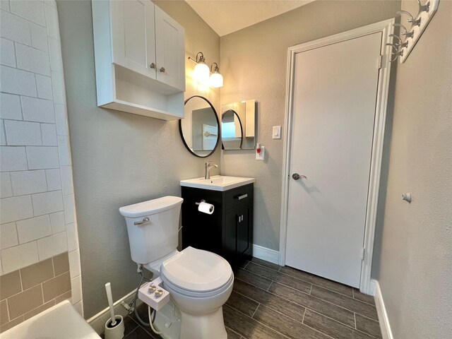 37 Ranch House Loop, Angleton, TX 77515 - full bathroom featuring toilet, baseboards, vanity, wood finish floors, and a tub