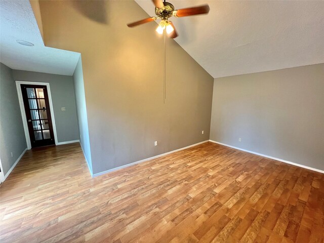 37 Ranch House Loop, Angleton, TX 77515 - spare room with light wood-type flooring, baseboards, a ceiling fan, and lofted ceiling