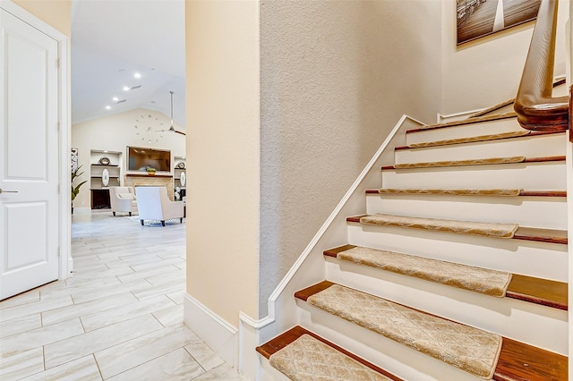 staircase with baseboards, high vaulted ceiling, and recessed lighting