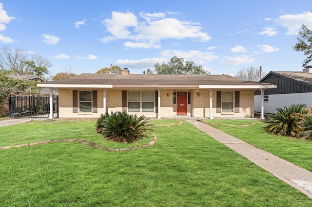 ranch-style house featuring a front lawn, brick siding, a chimney, and a porch