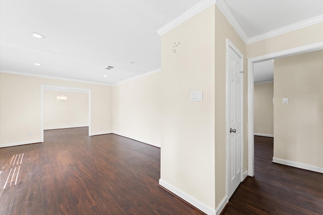 spare room featuring baseboards, ornamental molding, and dark wood-style floors