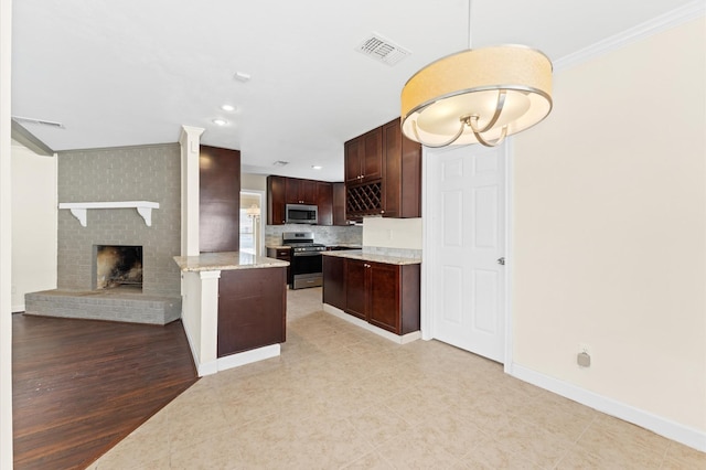 kitchen with dark brown cabinets, baseboards, ornamental molding, visible vents, and stainless steel appliances