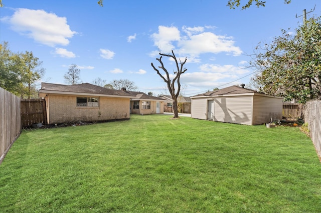 view of yard featuring an outdoor structure and a fenced backyard