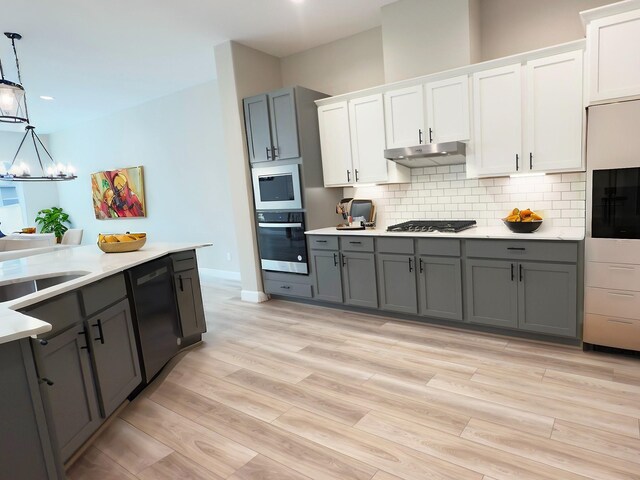 kitchen with dishwasher, oven, gray cabinetry, and stainless steel gas stovetop