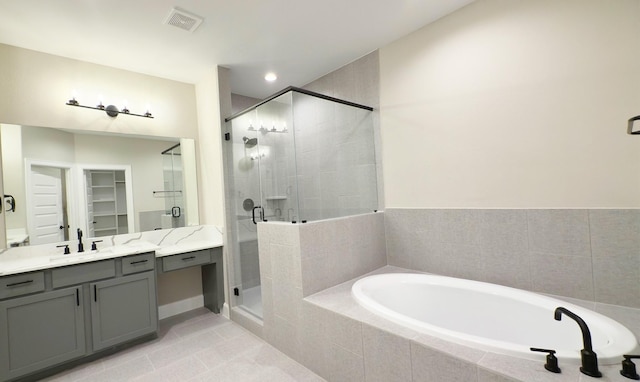 4307B Dickson St, Houston, TX 77007 - full bathroom featuring a garden tub, vanity, a shower stall, tile patterned flooring, and a walk in closet