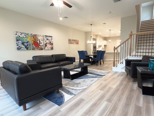 4307B Dickson St, Houston, TX 77007 - living area featuring a ceiling fan, stairway, light wood finished floors, a chandelier, and baseboards