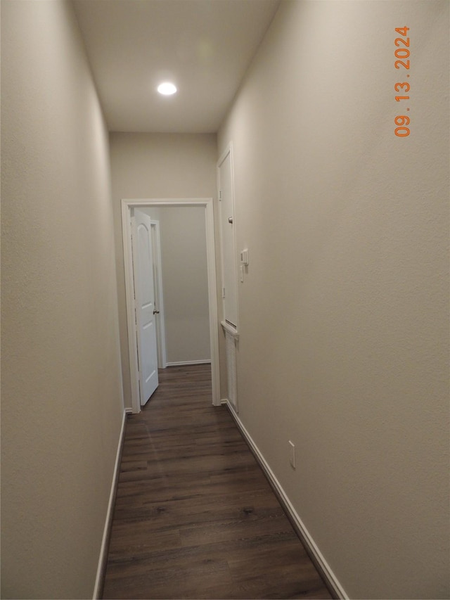 1100 Mann Rd, Conroe, TX 77303 - hall featuring dark wood-style flooring, baseboards, and recessed lighting