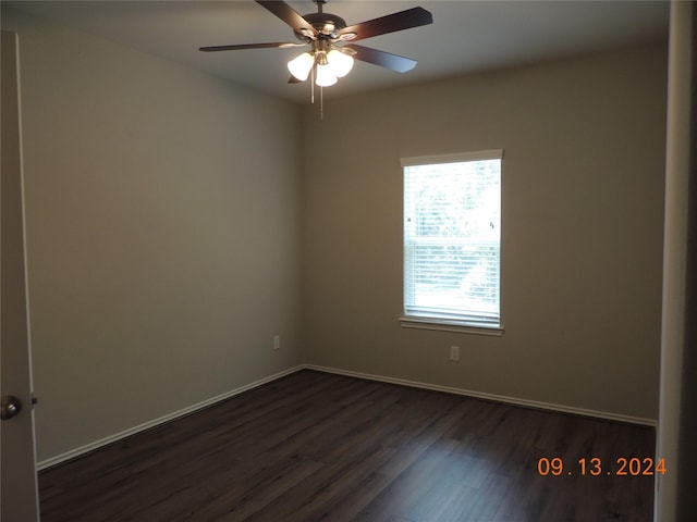 1100 Mann Rd, Conroe, TX 77303 - empty room featuring dark wood-style flooring, baseboards, and a ceiling fan
