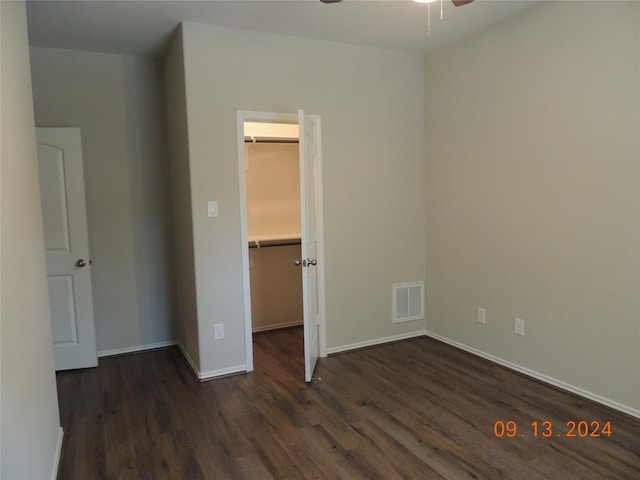 1100 Mann Rd, Conroe, TX 77303 - unfurnished bedroom with dark wood finished floors, visible vents, baseboards, and a spacious closet